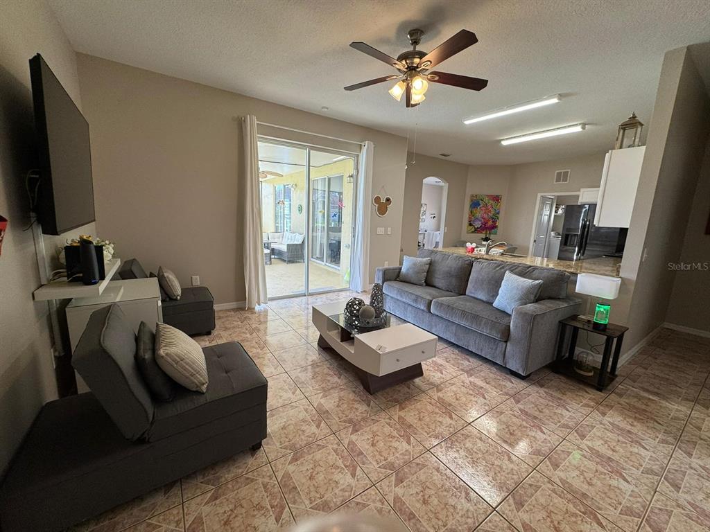 2526 Jasmine Trace Drive Kissimmee, FL 34758 - Photo 12 of 31 a living room with furniture and a flat screen tv