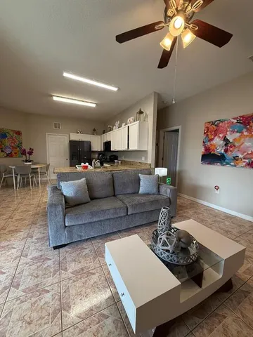 a living room with furniture and a dining area
