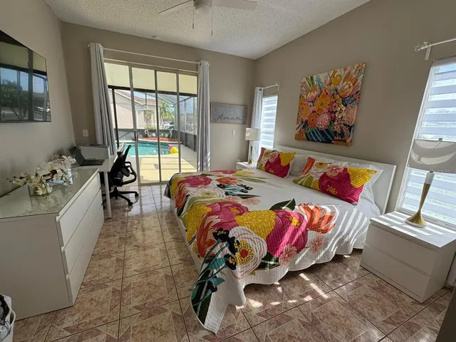 a bed sitting in a bedroom next to a window