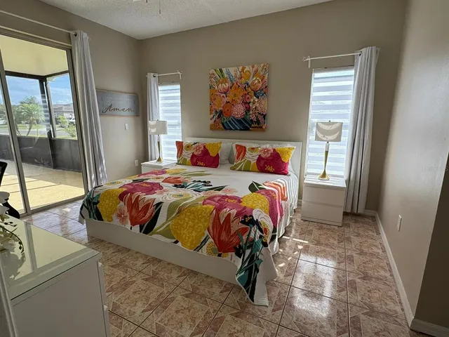 a bedroom with a bed and a painting on the wall