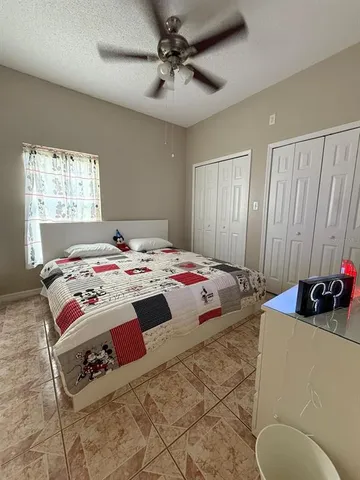 a bedroom with bed and a window