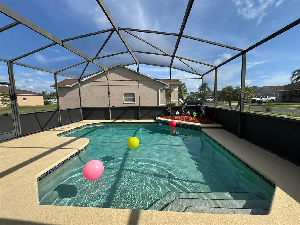 2526 Jasmine Trace Drive Kissimmee, FL 34758 - Photo 2 of 31 a view of a backyard with a table and chairs