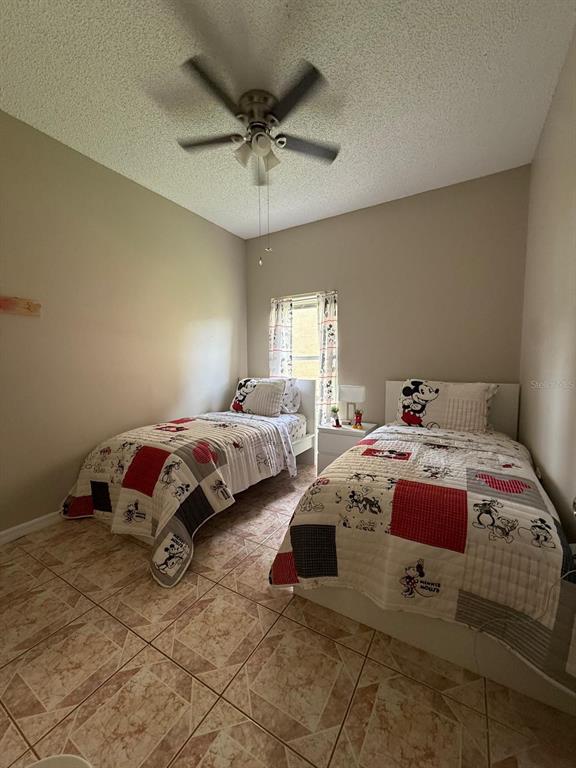 2526 Jasmine Trace Drive Kissimmee, FL 34758 - Photo 21 of 31 a bedroom with bed and window