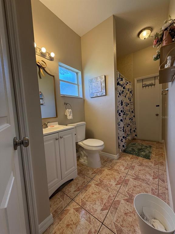 2526 Jasmine Trace Drive Kissimmee, FL 34758 - Photo 22 of 31 a bathroom with a sink toilet and shower