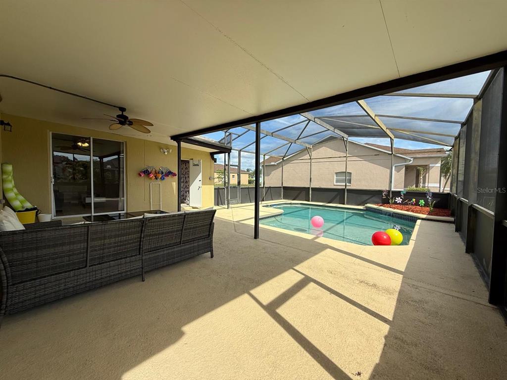 2526 Jasmine Trace Drive Kissimmee, FL 34758 - Photo 29 of 31 a living room with furniture and a flat screen tv