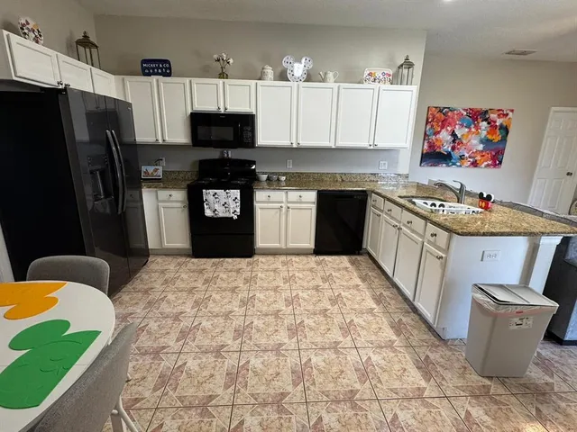 a kitchen with a sink stove and refrigerator