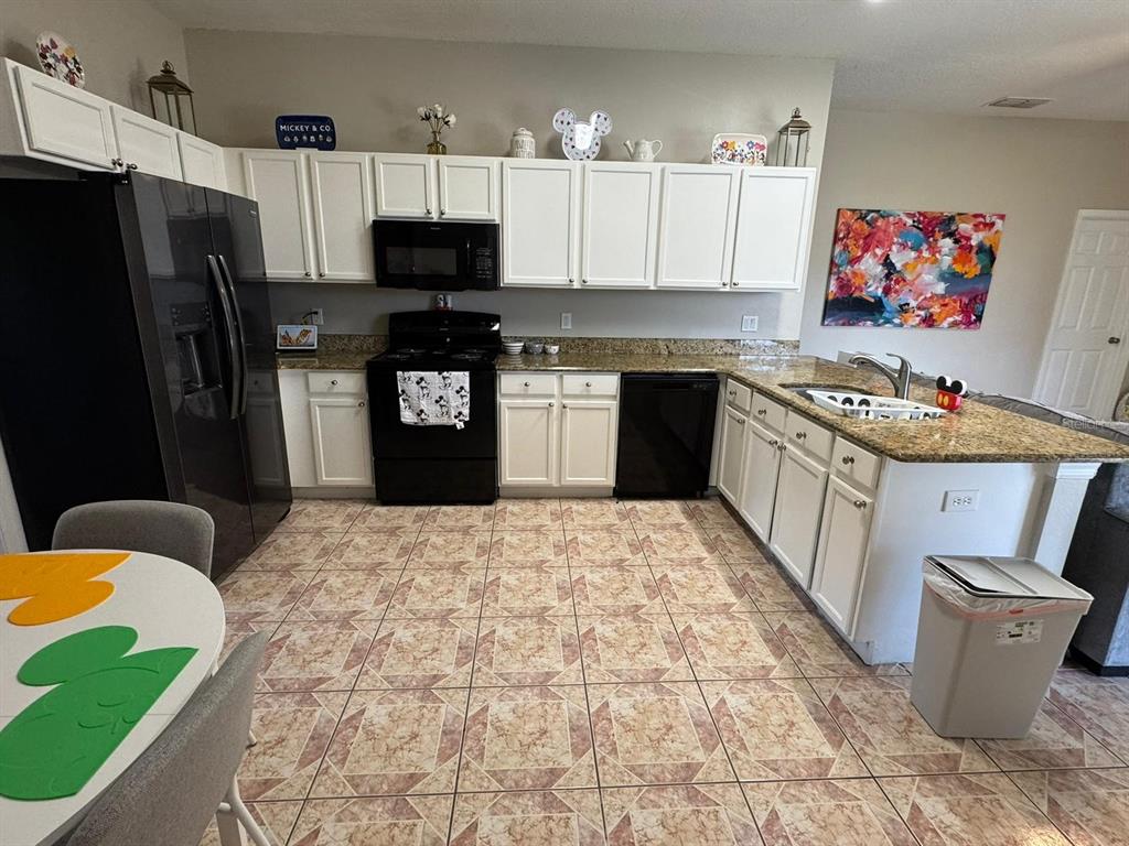 2526 Jasmine Trace Drive Kissimmee, FL 34758 - Photo 9 of 31 a kitchen with a sink stove and refrigerator