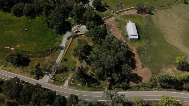 an aerial view of a residential houses with outdoor space