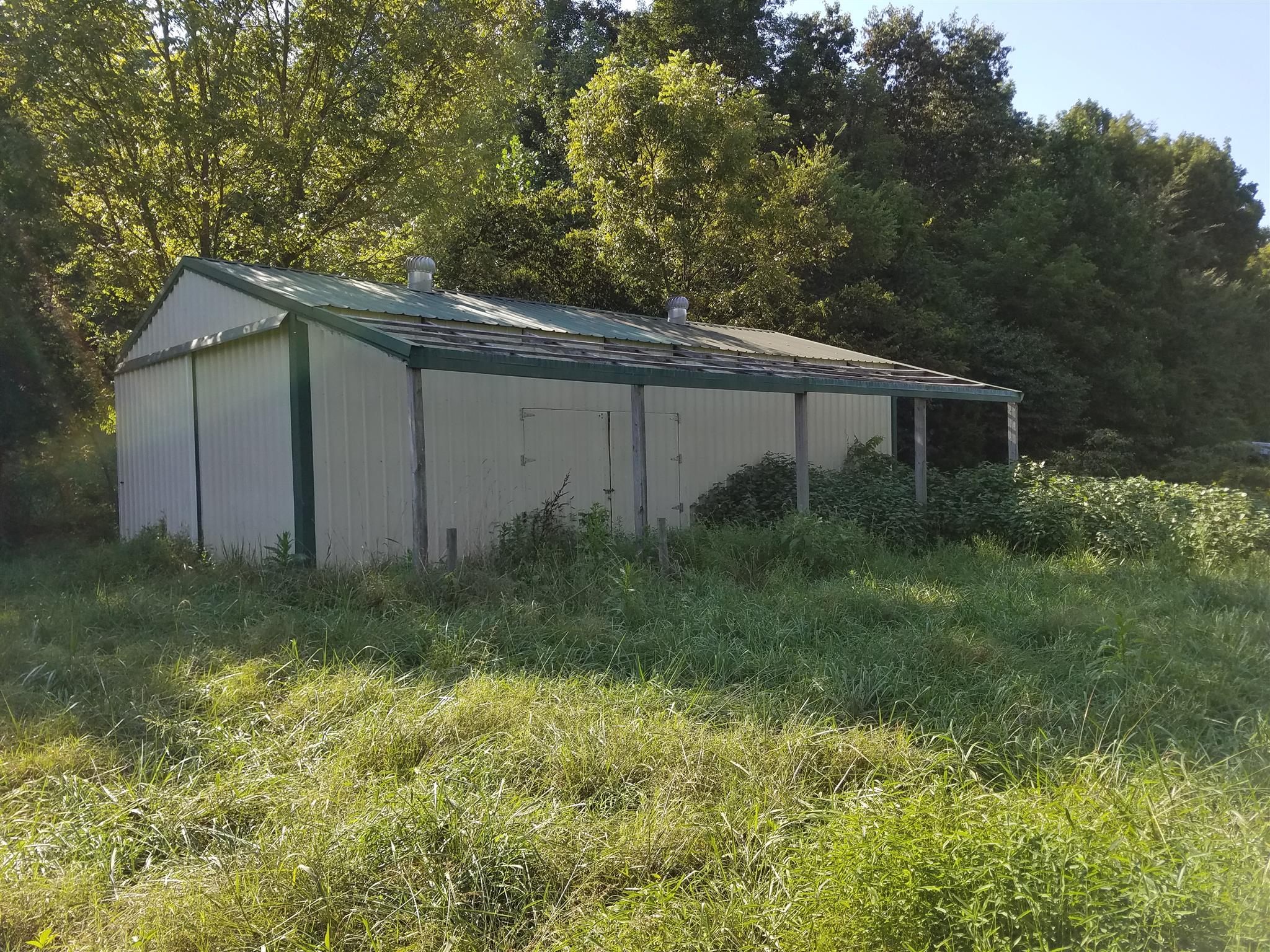 1925 Rock Bridge Road Bethpage, TN 37022 - Photo 4 of 18 a backyard of a house with plants and large trees