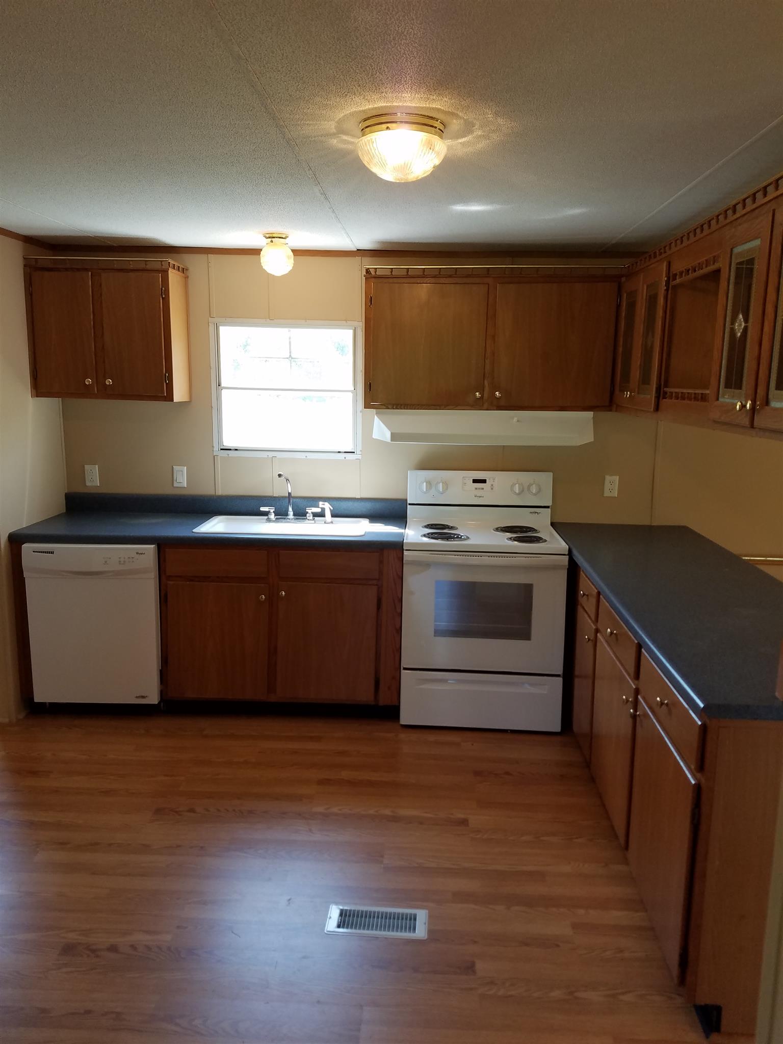 1925 Rock Bridge Road Bethpage, TN 37022 - Photo 8 of 18 a kitchen with stainless steel appliances granite countertop a sink stove and refrigerator