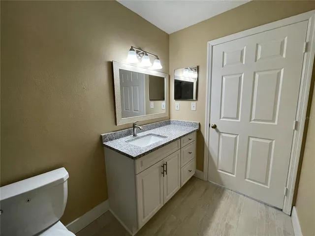 a bathroom with a double vanity sink and mirror