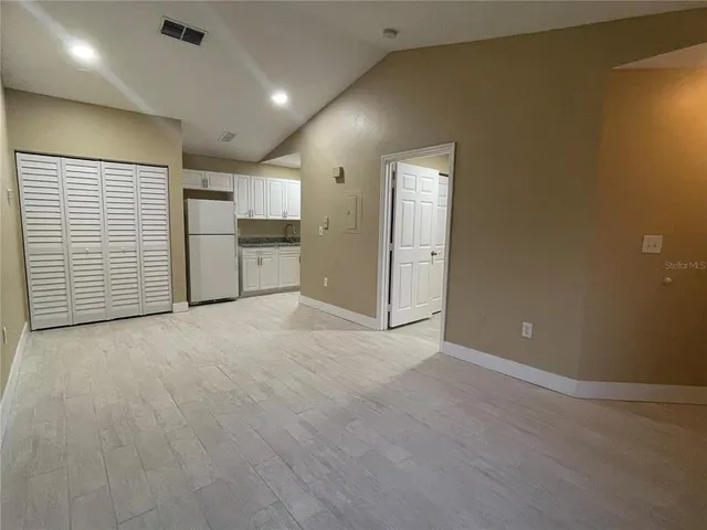 an empty room with a kitchen