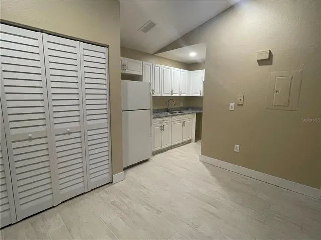 a view of a kitchen with white cabinets