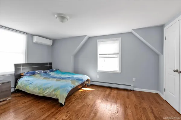 a bedroom with a bed and window