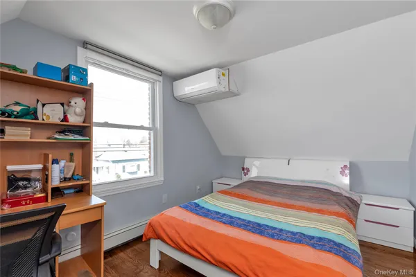 a bedroom with bed and a window