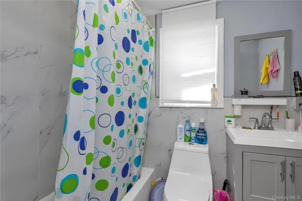a bathroom with a sink a vanity and a painting on the wall