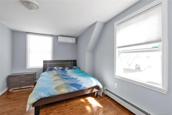 a bed sitting in a bedroom next to a window