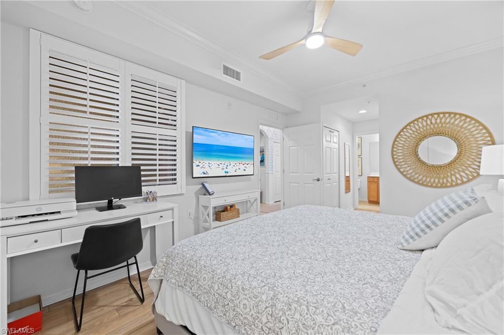 9715 Acqua Court, Unit 116 Naples, FL 34113 - Photo 12 of 43 a bedroom with a bed desk and chair