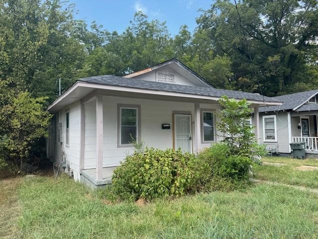 1559 Harrison Street Memphis, TN 38108 - Photo 2 of 11 Bungalow-style house with covered porch, roof with shingles, and a front lawn