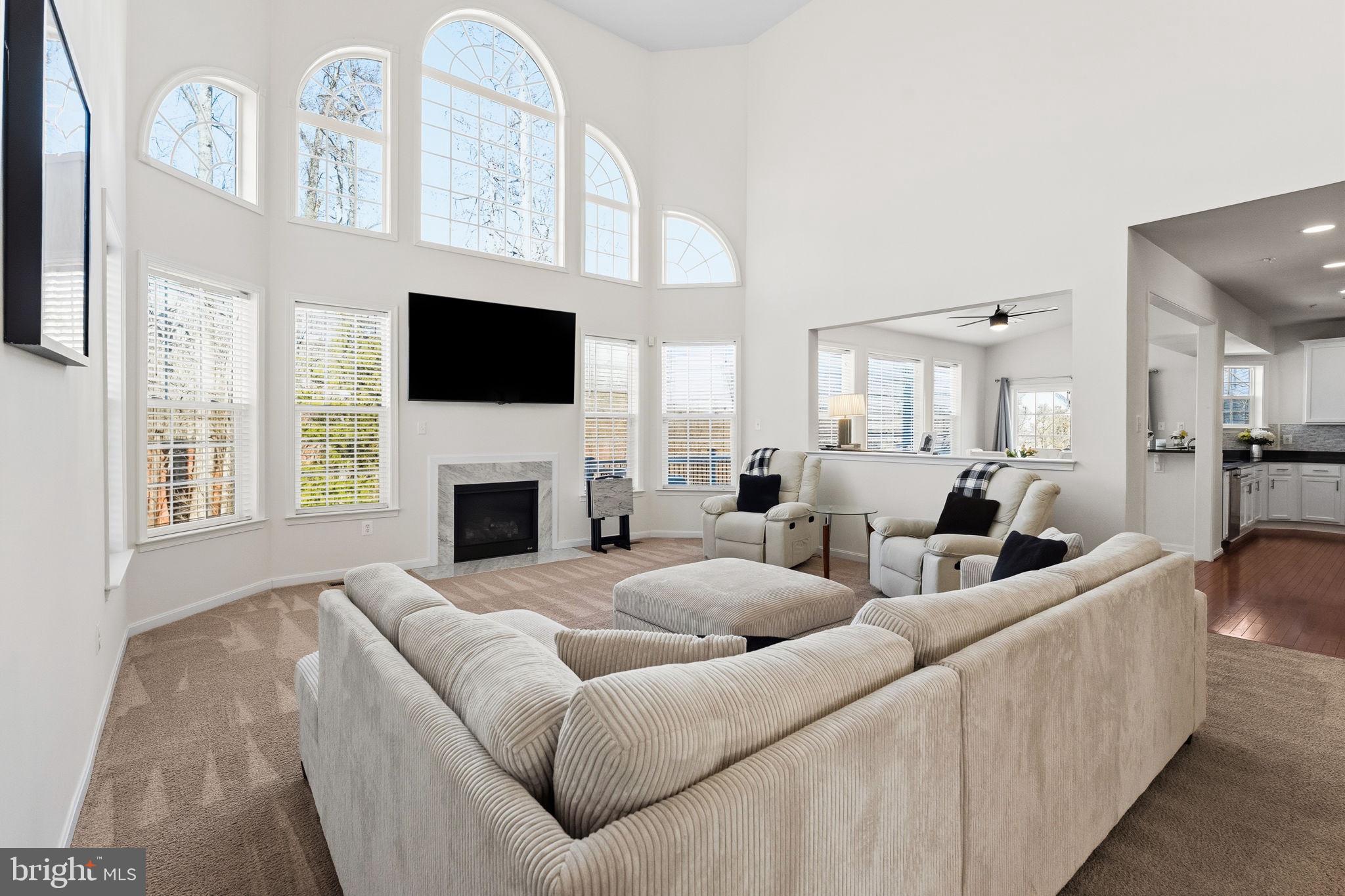 11904 Parallel Road Bowie, MD 20720 - Photo 15 of 86 a living room with furniture a flat screen tv and a fireplace