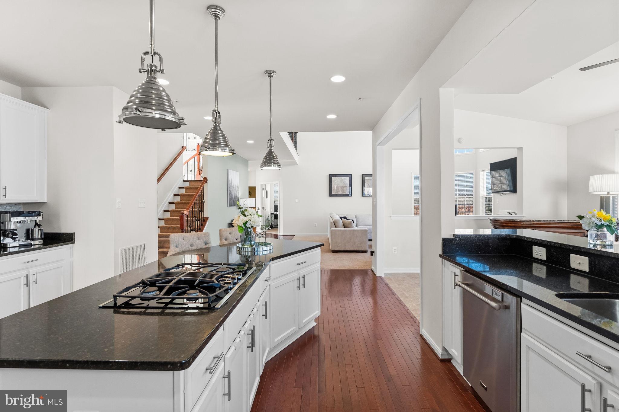 11904 Parallel Road Bowie, MD 20720 - Photo 24 of 86 a kitchen with granite countertop a stove a sink a refrigerator and wooden floor
