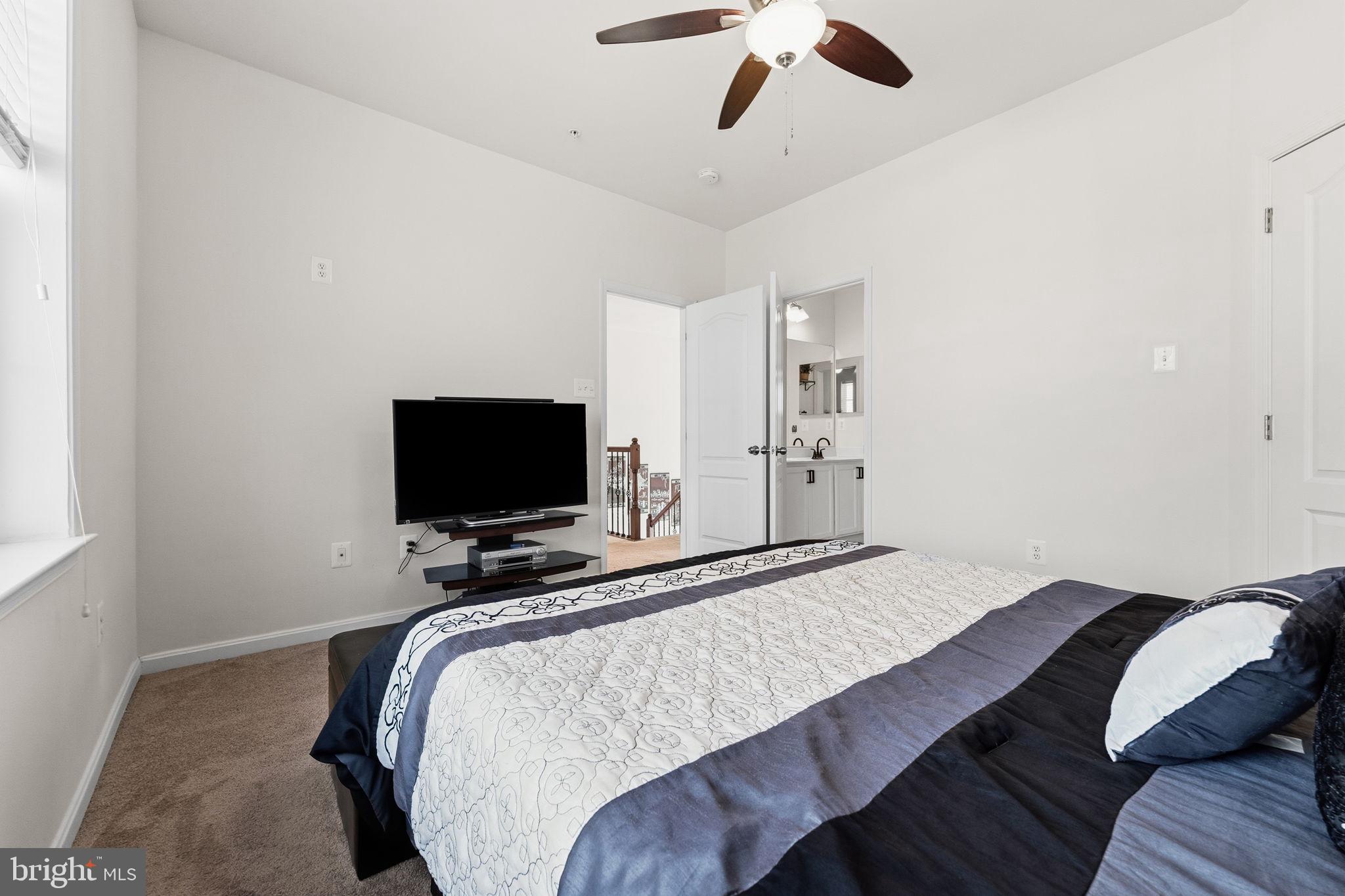 11904 Parallel Road Bowie, MD 20720 - Photo 50 of 86 a bedroom with a bed and flat screen tv