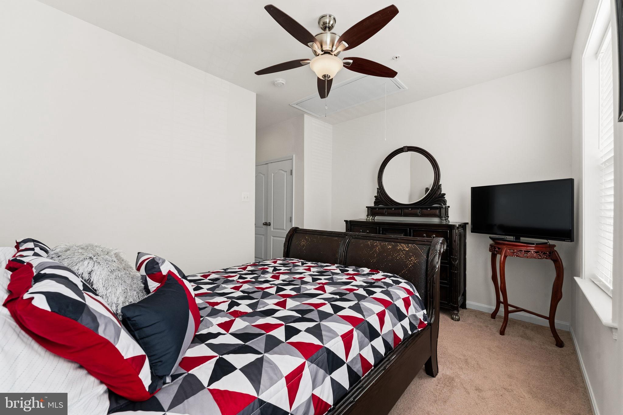 11904 Parallel Road Bowie, MD 20720 - Photo 52 of 86 a bedroom with a bed and a flat screen tv