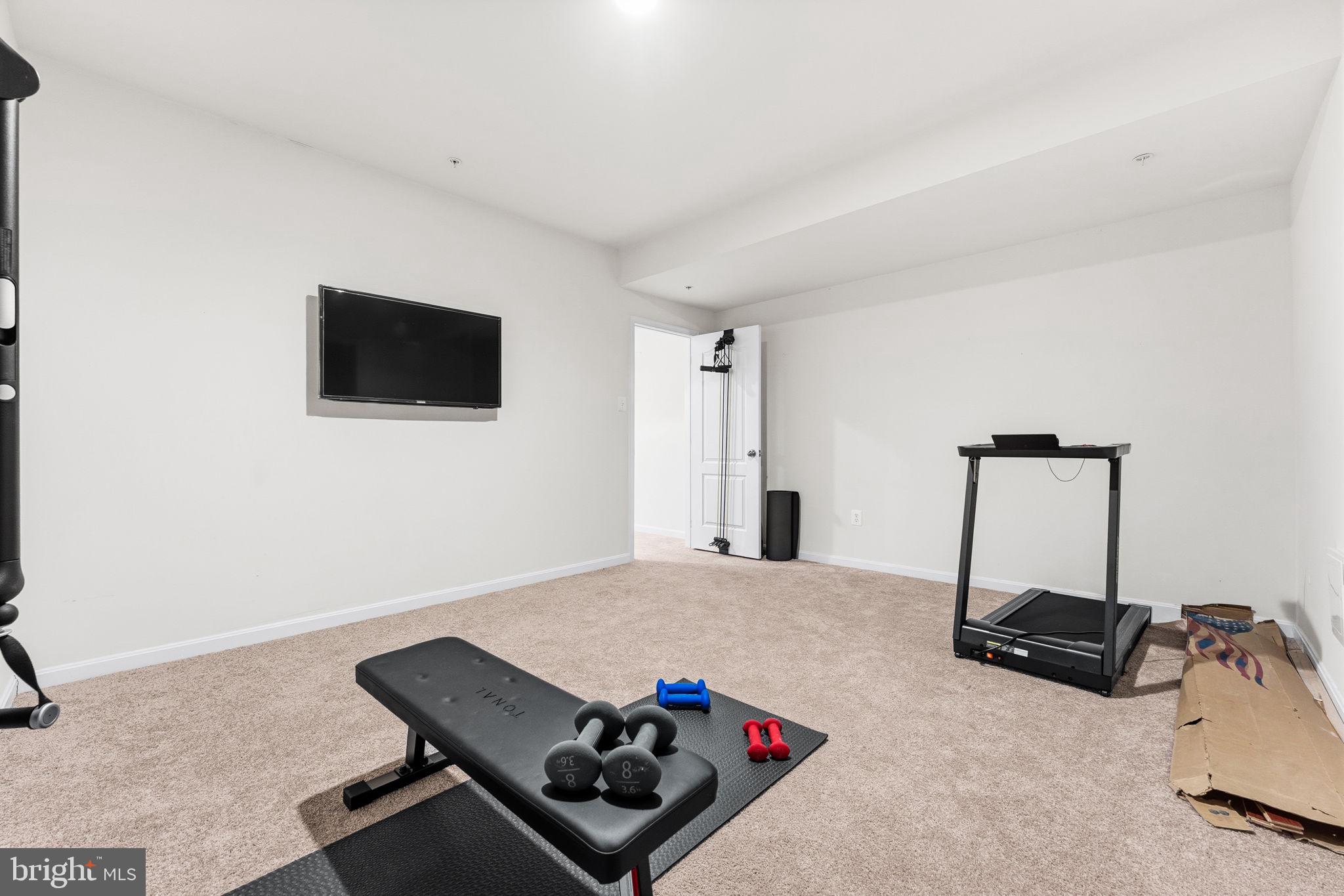 11904 Parallel Road Bowie, MD 20720 - Photo 65 of 86 a bedroom with furniture and a flat screen tv