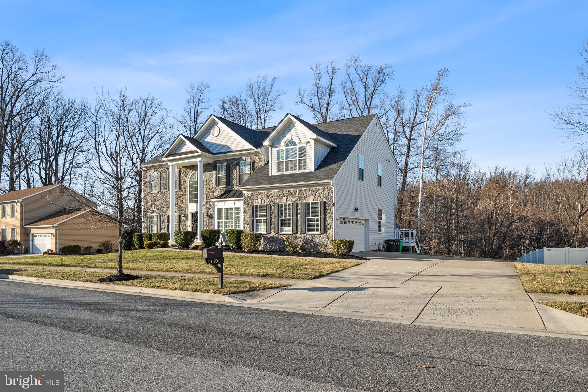 11904 Parallel Road Bowie, MD 20720 - Photo 85 of 86 a front view of a house with a yard