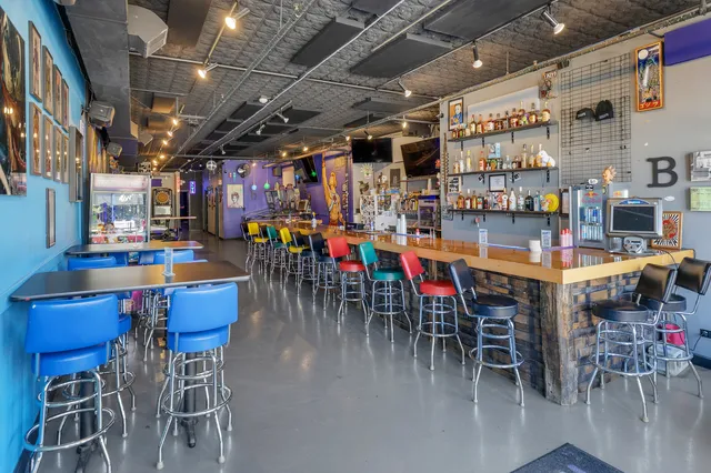 a dining room with lots of furniture and a chandelier