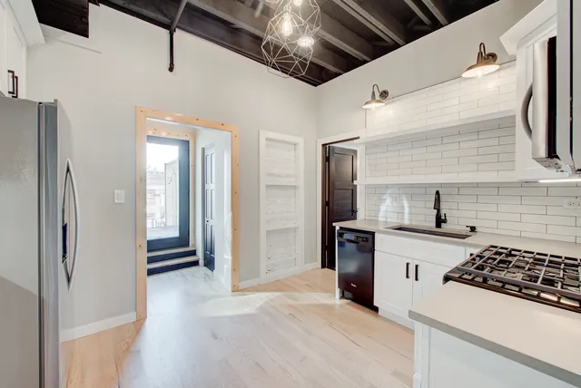 a kitchen with refrigerator and cabinets