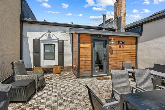 a view of a workspace room with furniture and wooden floor