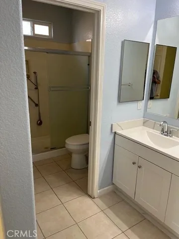 a bathroom with a sink a toilet and mirror