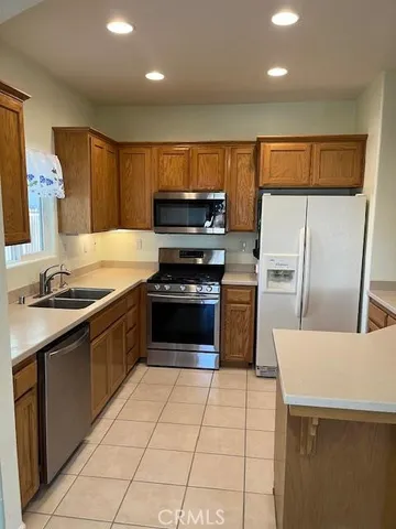 a kitchen with a sink a stove and refrigerator