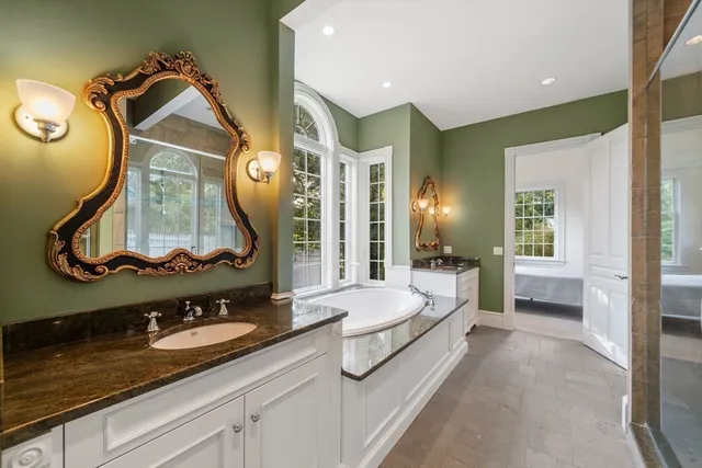 a spacious en suite bathroom with a double vanity sink and a mirror