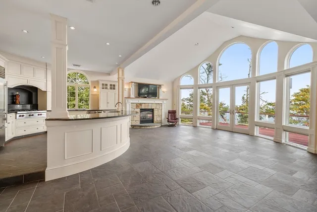 a large white kitchen with a large window