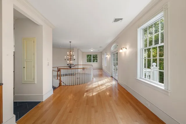 a view of a room with wooden floor and windows