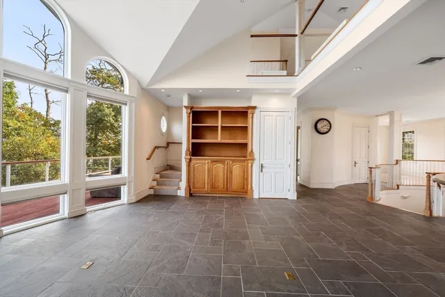 a view of an empty room with a fireplace and a window