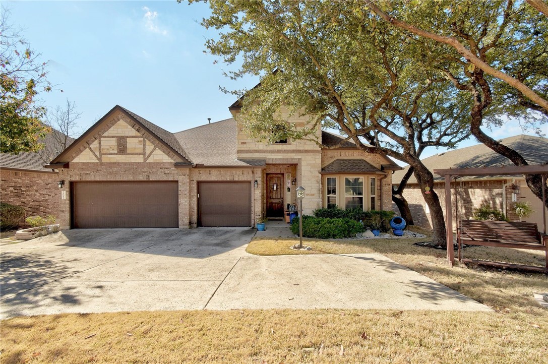 209 Bellagio Drive Lakeway, TX 78734 - Photo 1 of 1 a front view of a house with a yard and garage