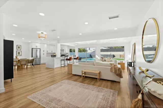 a living room with furniture and a large mirror