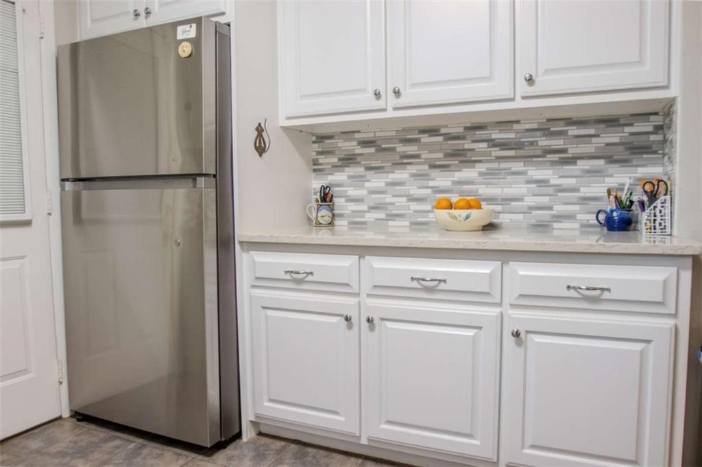 849 Bobbin Mill Road Athens, GA 30606 - Photo 11 of 32 a kitchen with white cabinets and white appliances