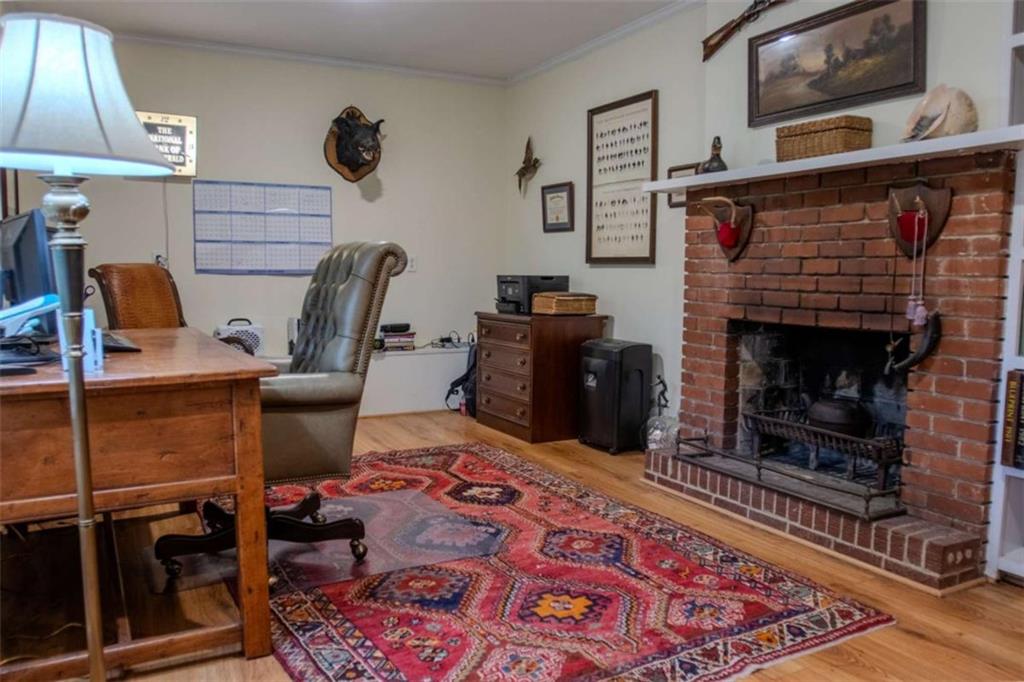 849 Bobbin Mill Road Athens, GA 30606 - Photo 22 of 32 a work room with furniture a rug and a fireplace