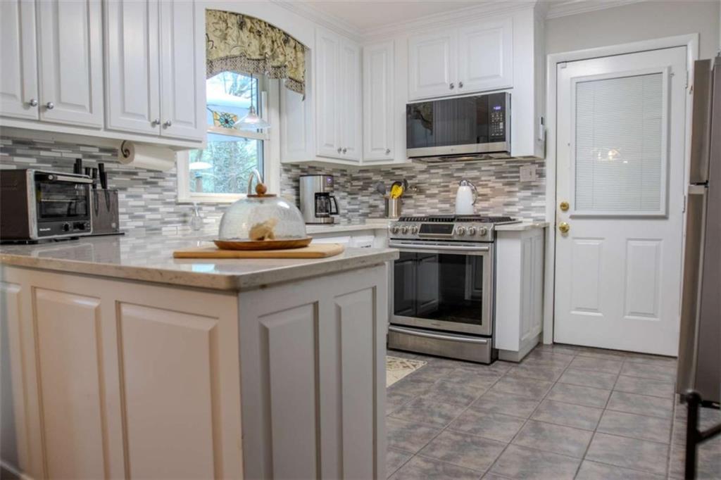 849 Bobbin Mill Road Athens, GA 30606 - Photo 9 of 32 a kitchen with stainless steel appliances granite countertop a stove a sink and a microwave