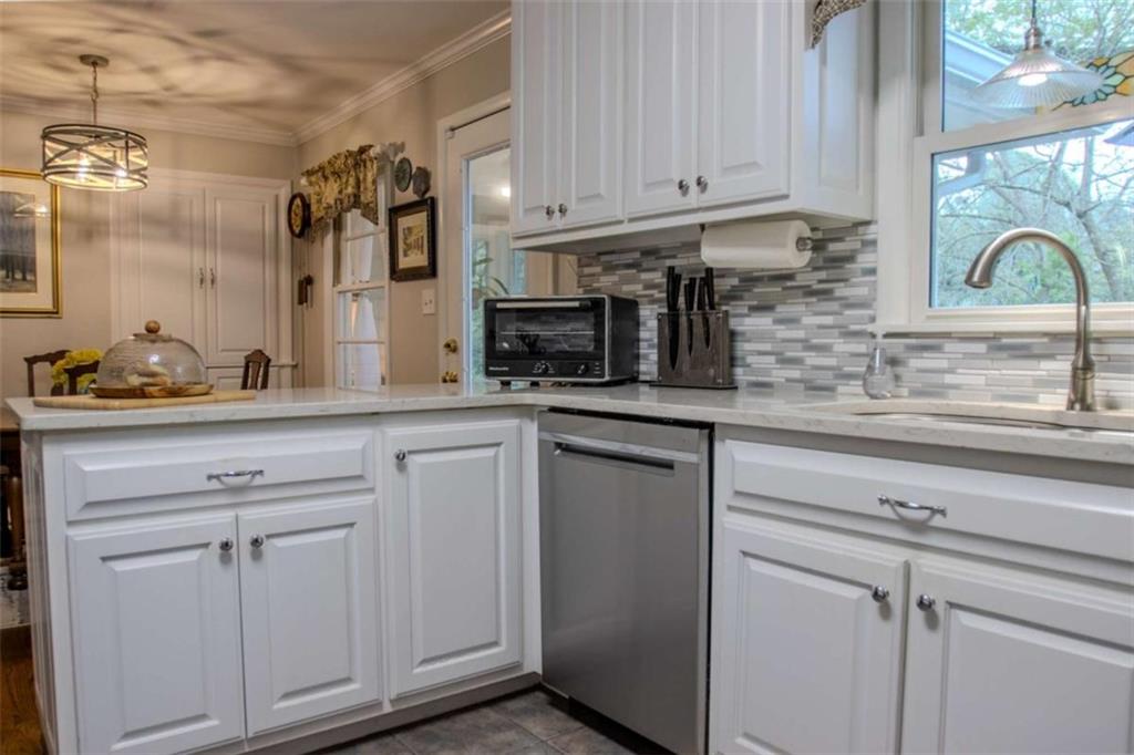 849 Bobbin Mill Road Athens, GA 30606 - Photo 10 of 32 a kitchen with stainless steel appliances granite countertop white cabinets and a sink