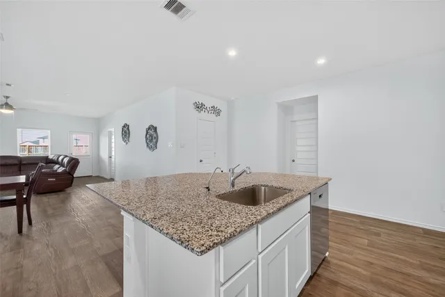 a kitchen with sink and mirror