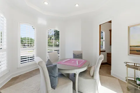 an empty room with windows and cabinet