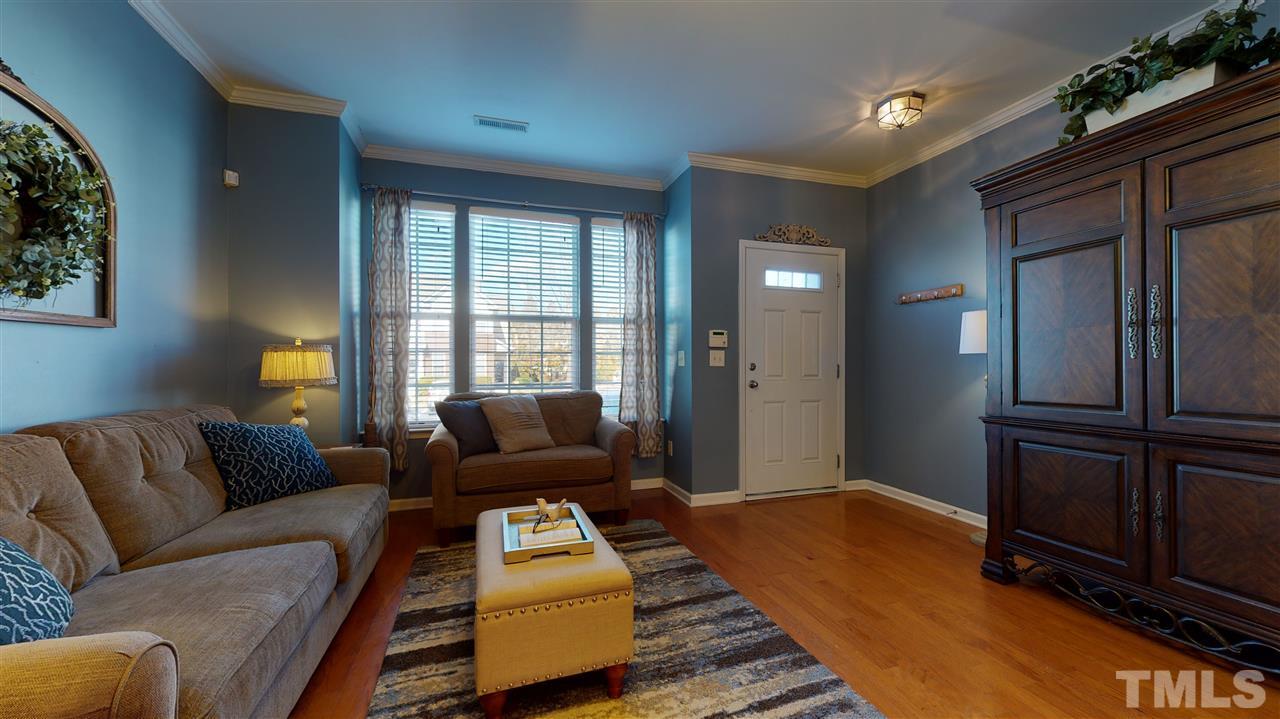 7621 Winners Edge Street Raleigh, NC 27617 - Photo 2 of 30 a living room with furniture and wooden floor