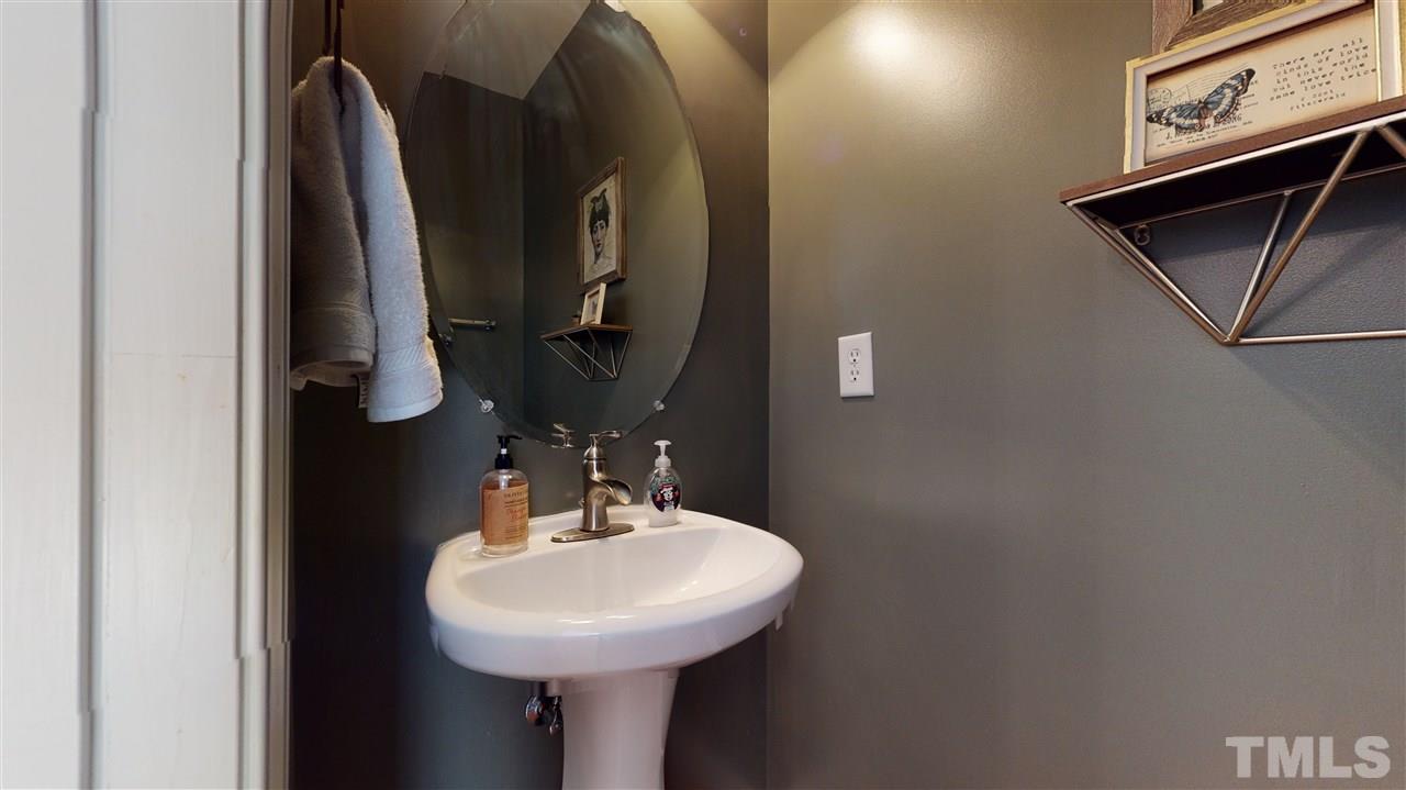 7621 Winners Edge Street Raleigh, NC 27617 - Photo 13 of 30 a bathroom with a sink and a mirror
