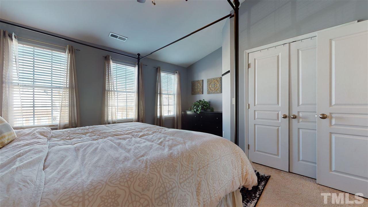 7621 Winners Edge Street Raleigh, NC 27617 - Photo 17 of 30 a spacious bedroom with a bed and a window