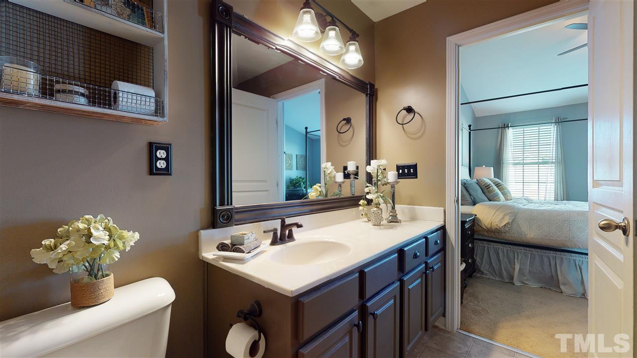 7621 Winners Edge Street Raleigh, NC 27617 - Photo 19 of 30 a bathroom with a sink vanity and a mirror